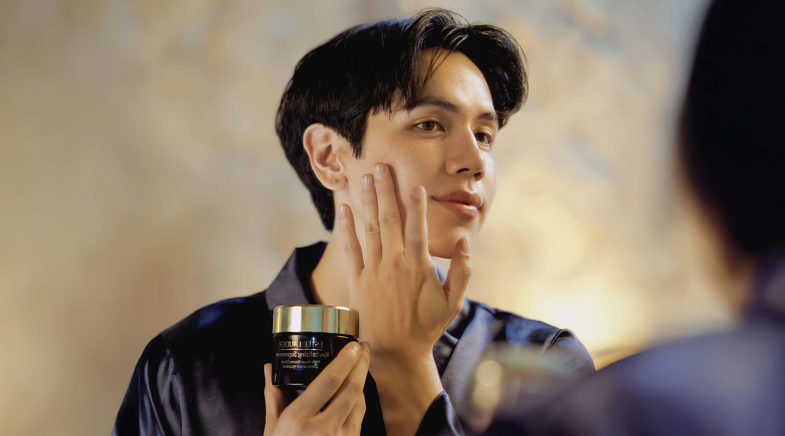 BJ Pascual applying the Revitalizing Supreme+ Night Power Bounce Creme Moisturizer